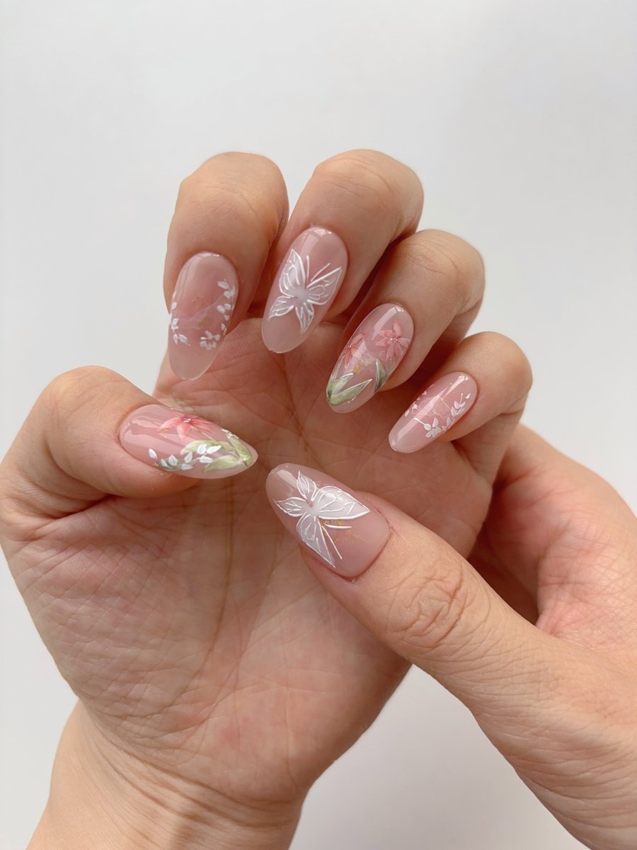 Elegant almond shaped press-on nails with dainty floral detailing