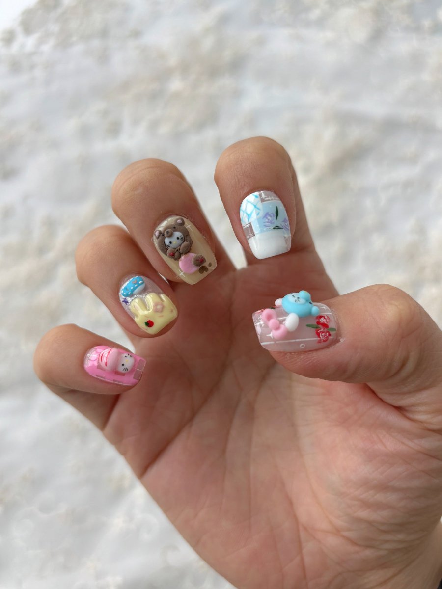 3D kawaii nail art set with bows, animals, and sweet motifs in soft pinks and blues