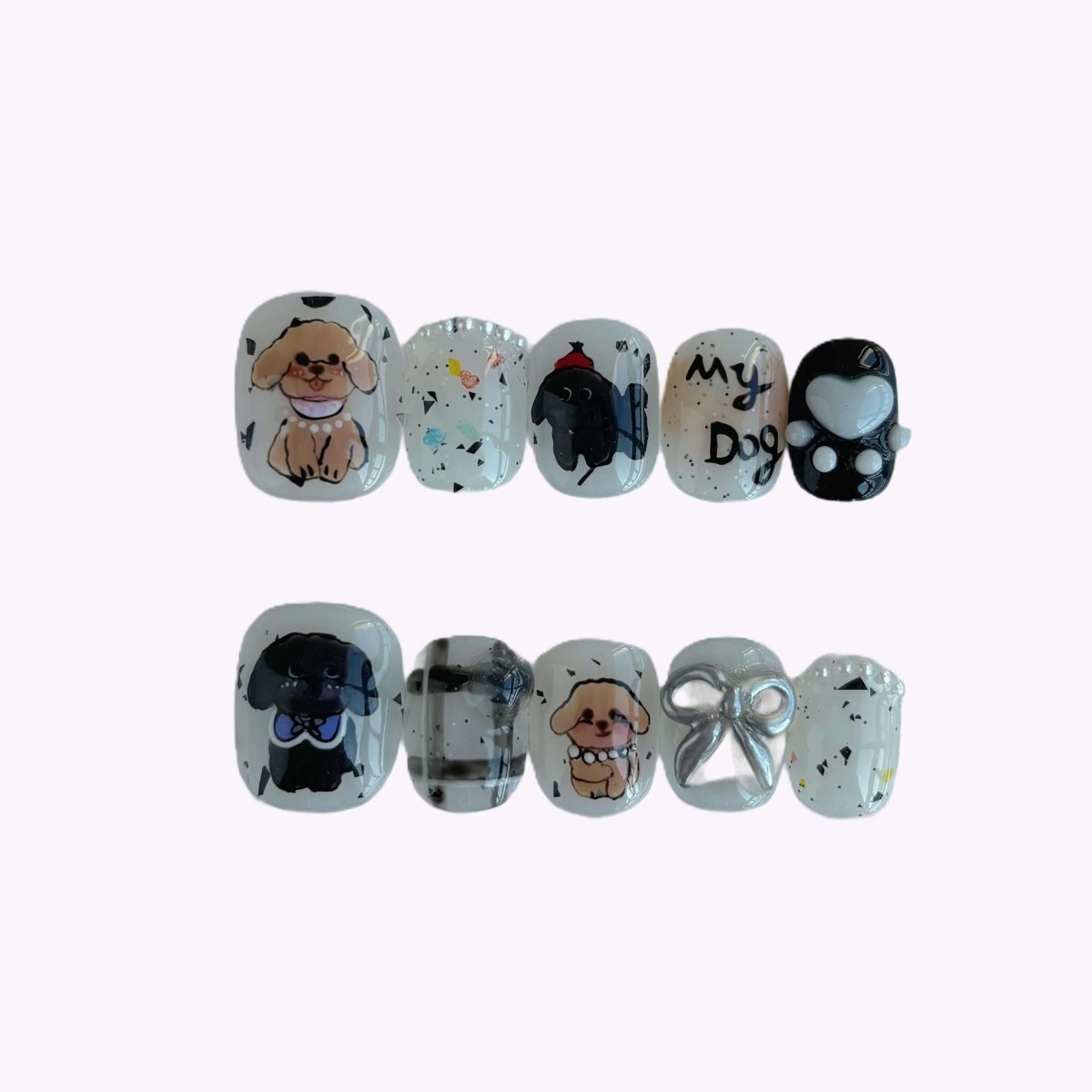 Ten-piece dog press-on nail set in neutral tones with pearl accents, cartoon dogs, and glitter detailing