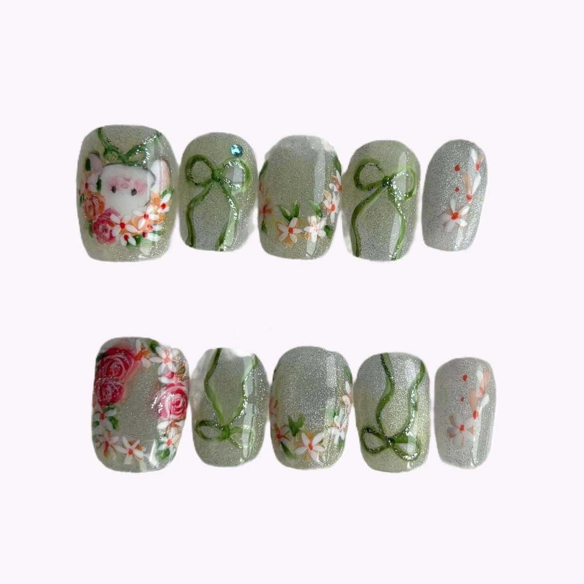 Bunny in Bloom short square press-on nail set laid out in case with botanical art