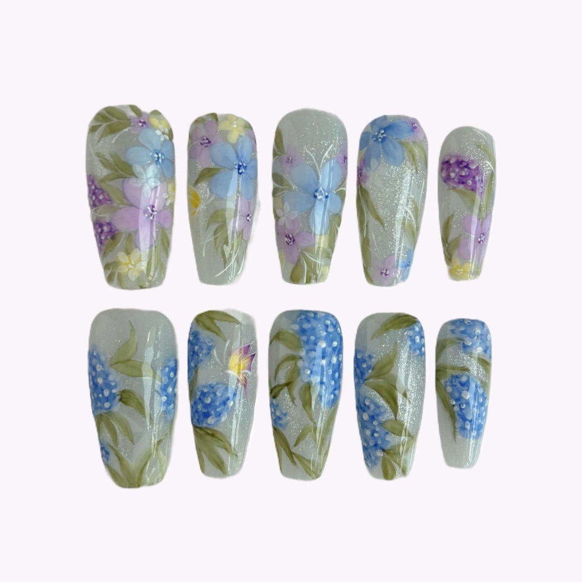 Handmade floral press-on nail set in long coffin shape inside case