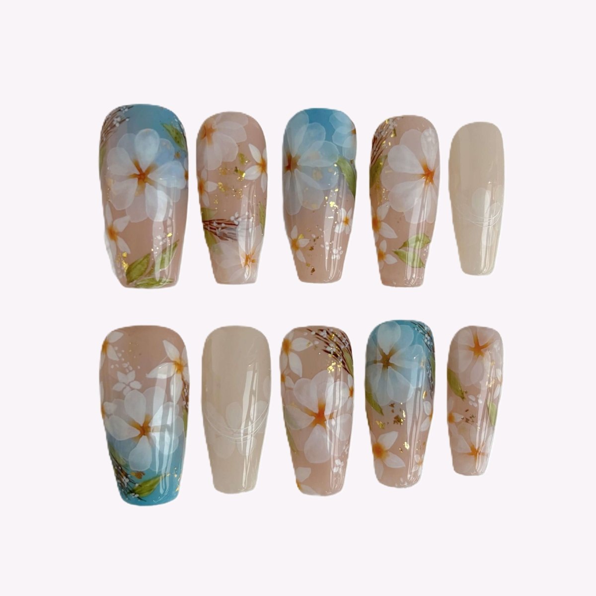 Long coffin press-on nails with hand-painted white daisy design on nude and blue gradient background