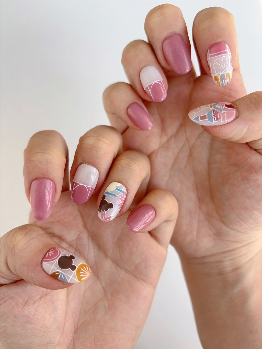 Glossy theme park-inspired press-on nails with warm vintage colors, abstract shapes, and shimmer details