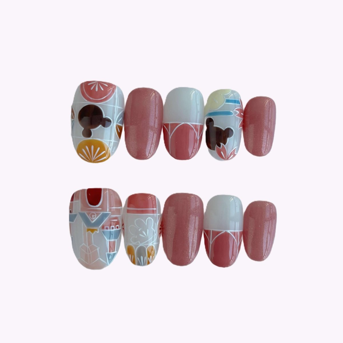 Ten-piece almond nail set featuring pink shimmer, white French tips, and geometric floral patterns