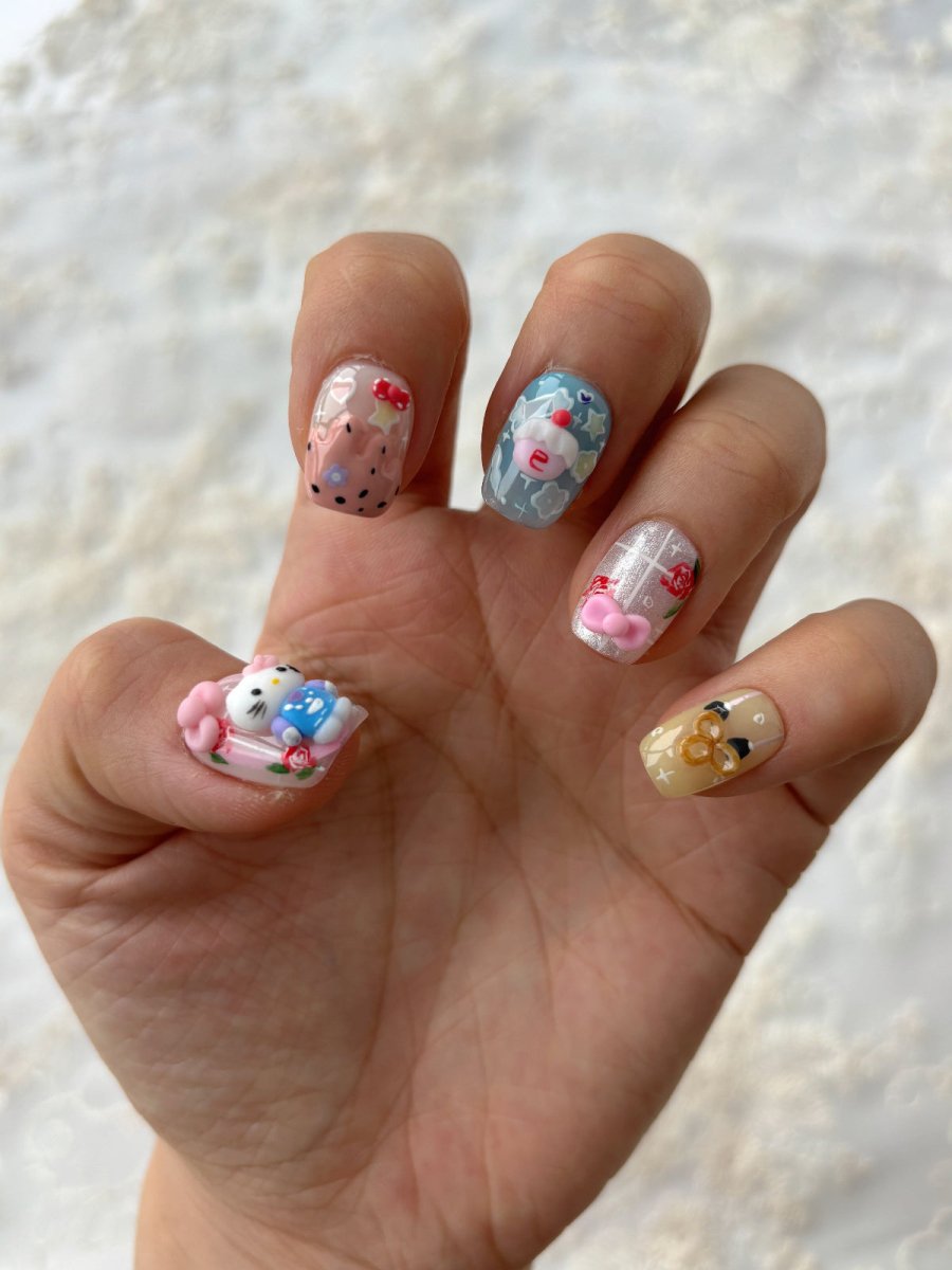 Detailed view of full 3D kawaii nail art set with bows, animals, and sweet motifs in soft pinks and blues