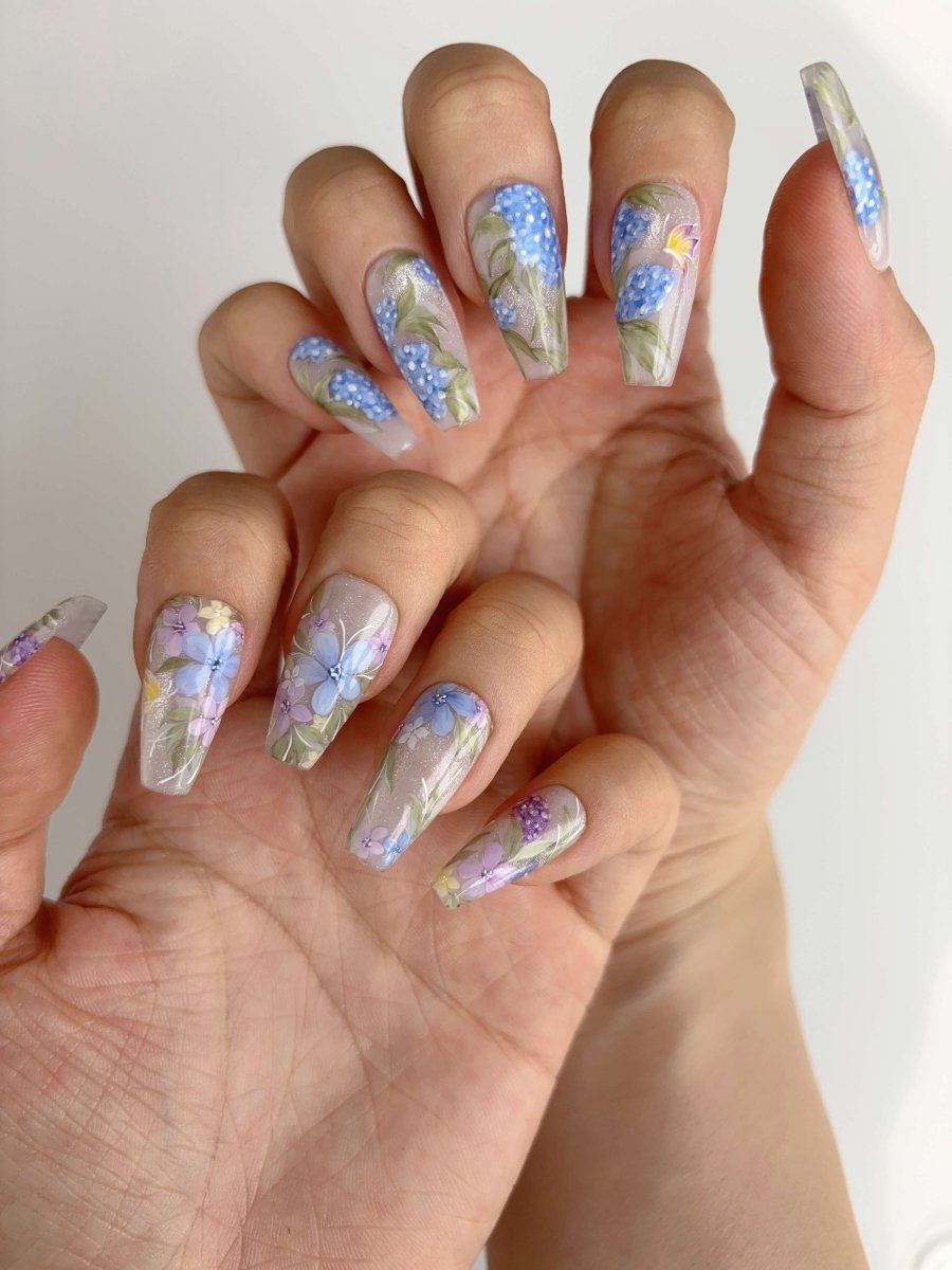 Press-on nails with hand-painted purple, blue, and green wildflowers