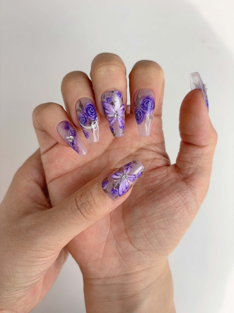 Romantic purple rose and butterfly press-on nail set styled on hands