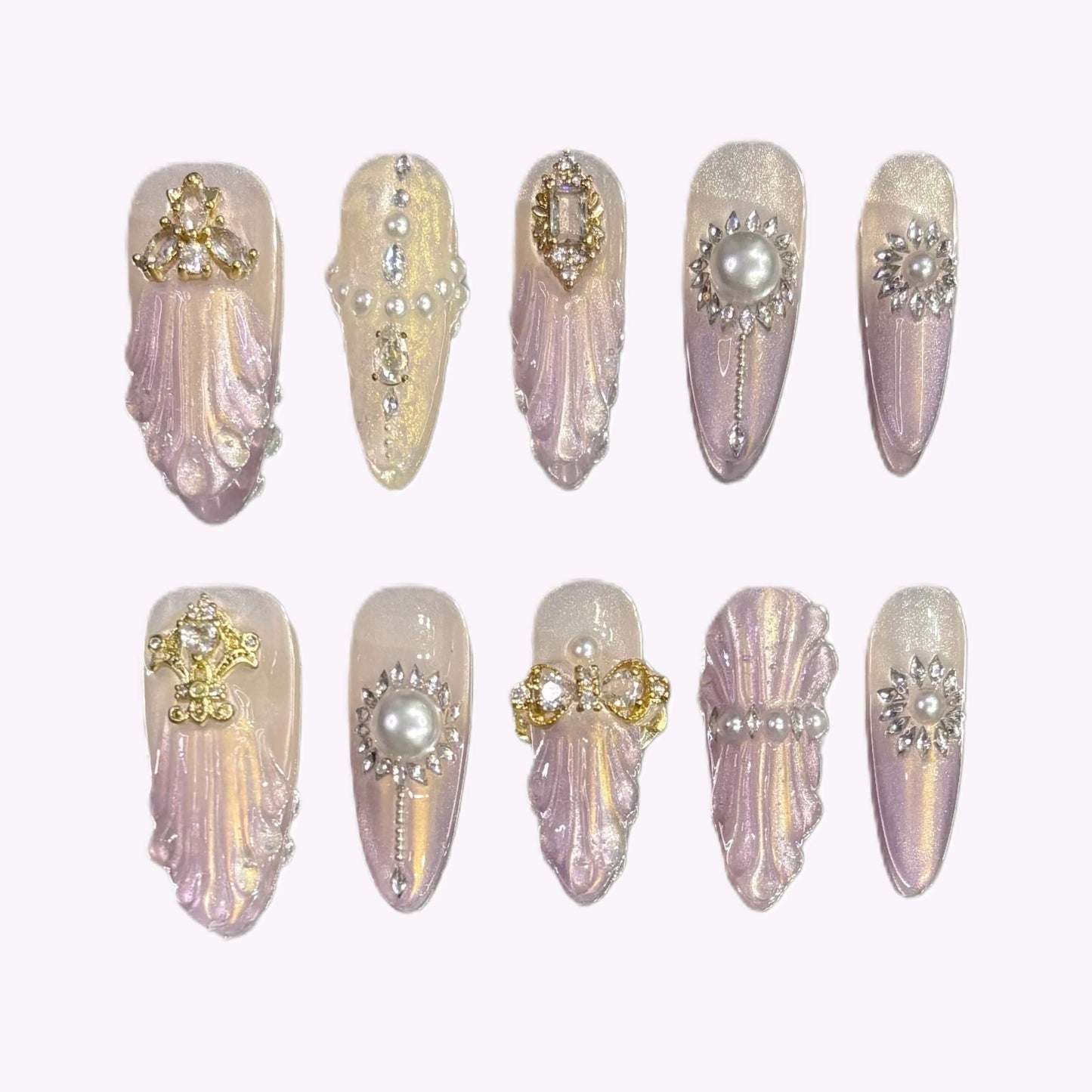 Flat lay of Royal Shell press-on nails with sculpted shell texture and pearl embellishments