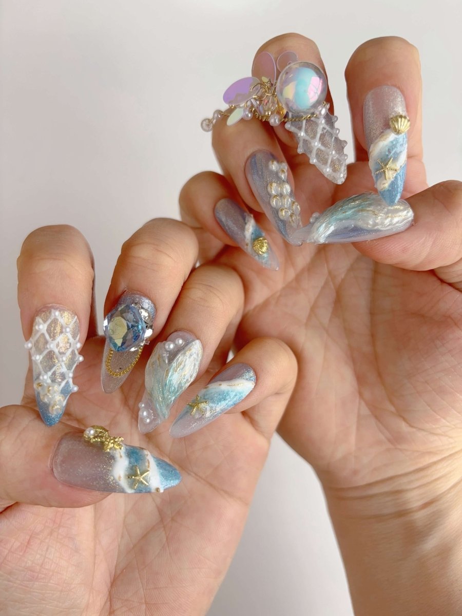 Full set of Mermaid's Treasure press-on nails styled on both hands with oceanic 3D elements and sequins