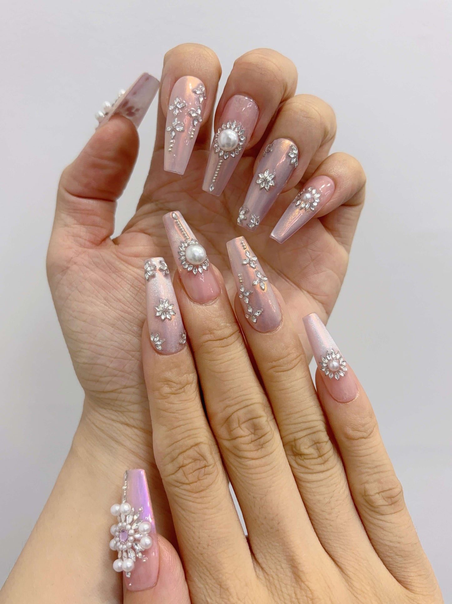 Side angle of Pearl Eclipse nails highlighting shimmer and 3D details