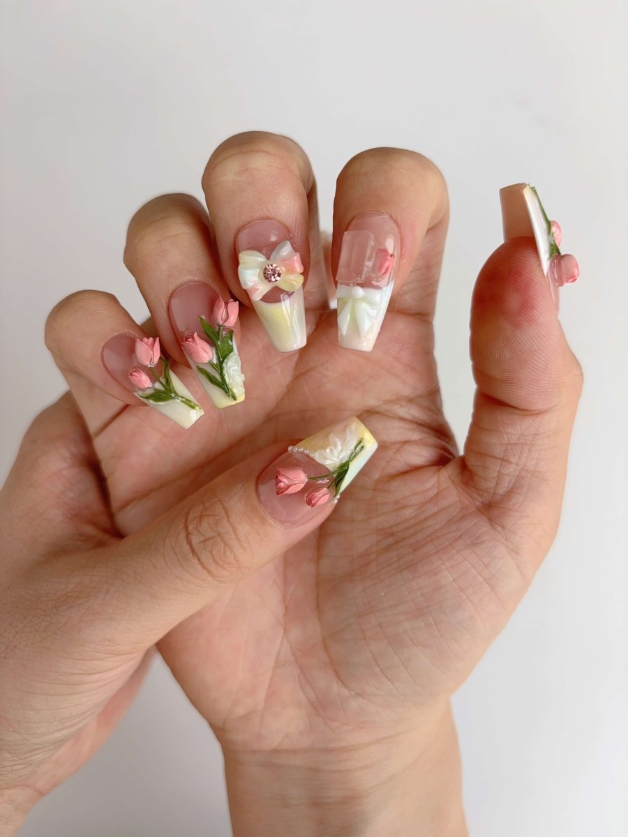 Nude pink and pearl floral press-on nails with crystal bow charm