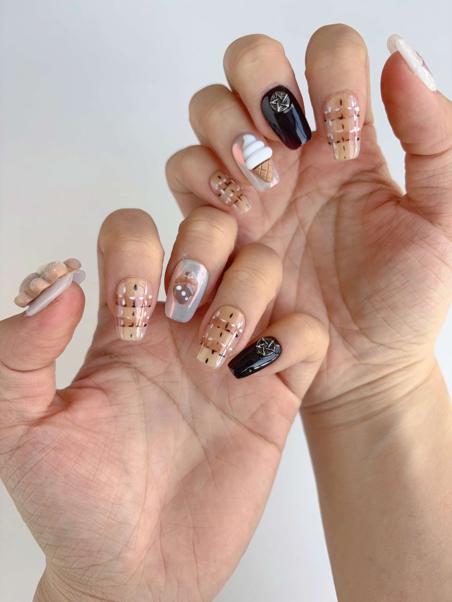Cute ice cream cone and teddy bear charm press-on nails shown on both hands