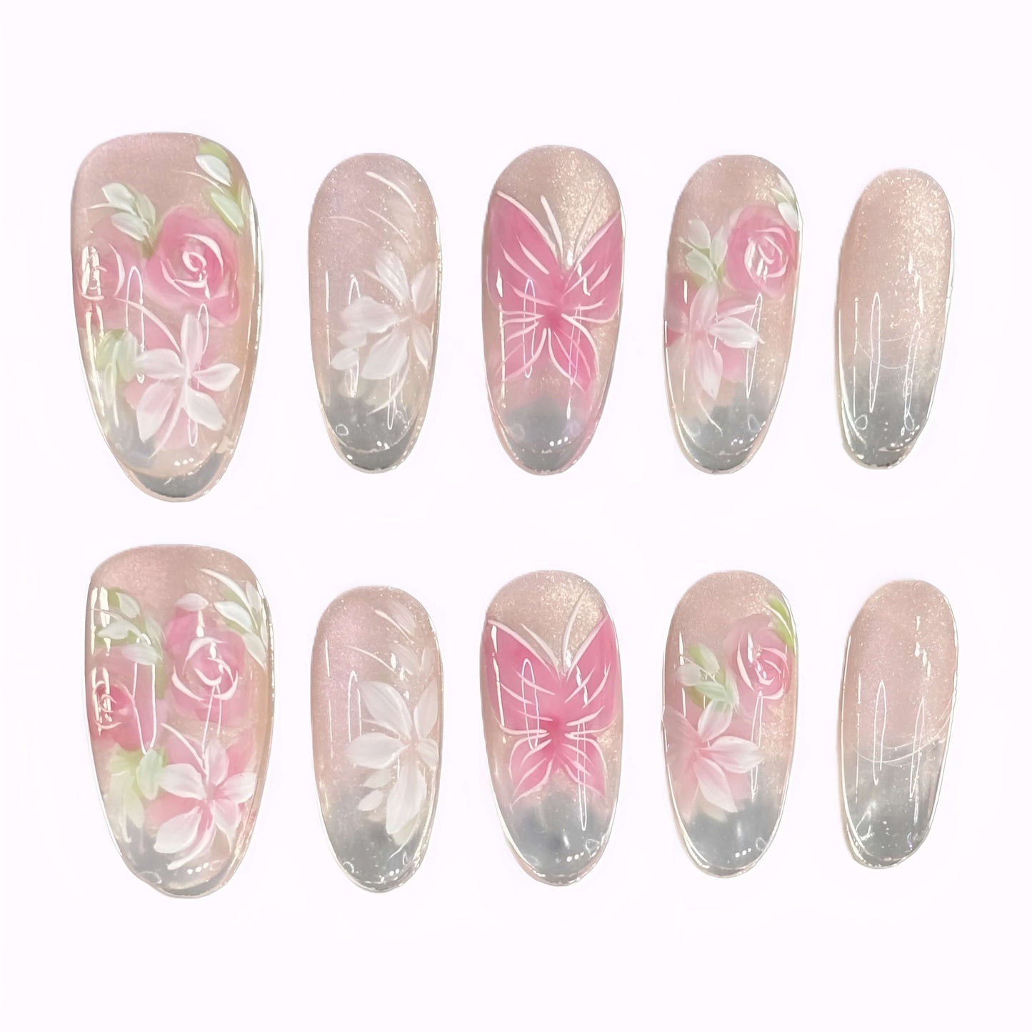 Flat lay of Rosé Reverie press-on nails with soft pink rose and butterfly designs