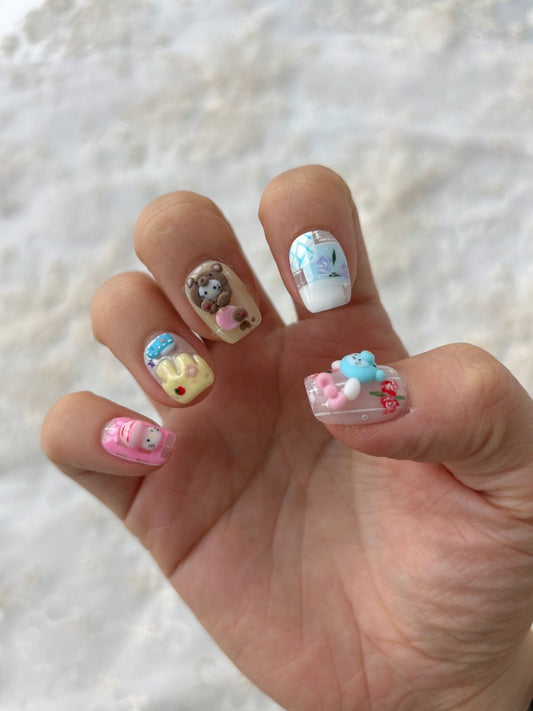 3D kawaii nail art set with bows, animals, and sweet motifs in soft pinks and blues