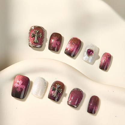 10-piece Garnet Eclipse press-on nail set with chrome frames, crosses, and cat eye finish