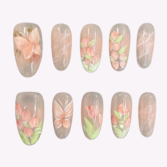Petal Veil press-on nails laid out with soft pink floral designs