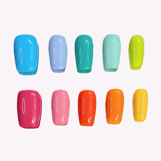 Technicolor Tips press-on nail set flat lay showing all 10 glossy rainbow nails