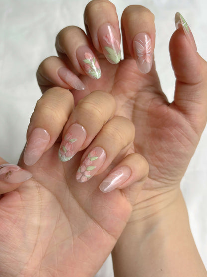 Two hands showing full Petal Veil press-on nail set in soft pink