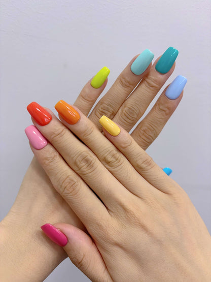 Hands posed to show Technicolor Tips press-on nails in solid bright colours