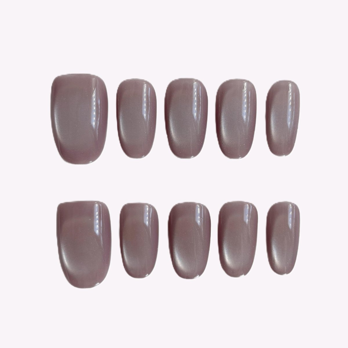 Dusty rose cat’s eye press-on nails on white background