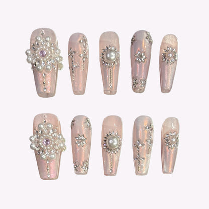 Flat lay of Pearl Eclipse press-on nails with 3D pearls and rhinestone clusters