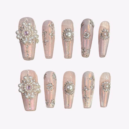 Flat lay of Pearl Eclipse press-on nails with 3D pearls and rhinestone clusters