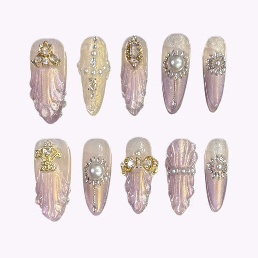 Flat lay of Royal Shell press-on nails with sculpted shell texture and pearl embellishments