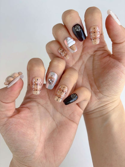 Cute ice cream cone and teddy bear charm press-on nails shown on both hands