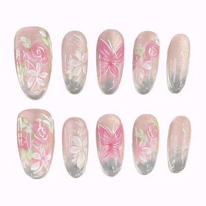Flat lay of Rosé Reverie press-on nails with soft pink rose and butterfly designs